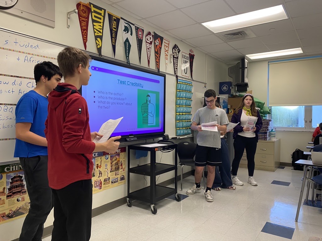Students presenting a digital literacy lesson in a classroom